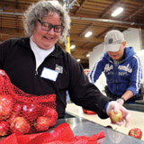The Alameda County Community Food Bank was an early adopter in formalizing their nutrition policies. Center: Allison Pratt and Jenny Lowe manage nutrition policy. Volunteers Kathy Herman and Jigme Norby package fresh produce. PHOTO: Molly Oleson