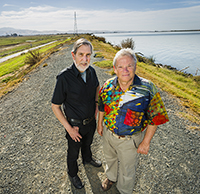 Professors and Delta Independent Science Board members Vincent Resh (right) and Richard Norgaard stand on a levee on Sherman Island along the Sacramento River.