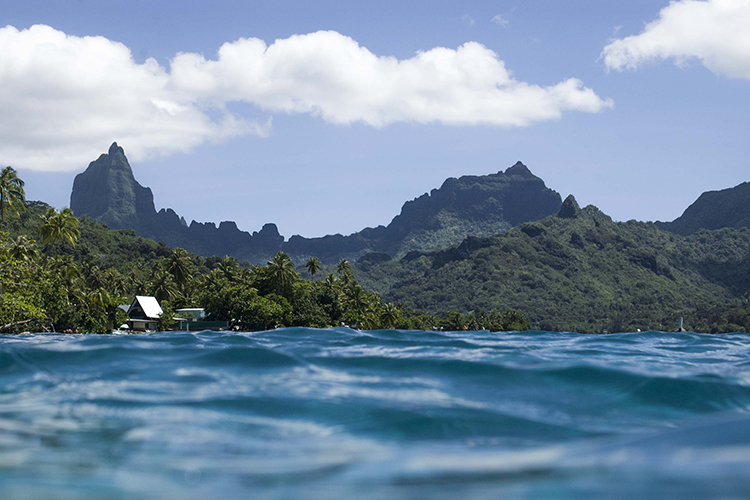 Photograph taken in the ocean with view of Moorea island mountains