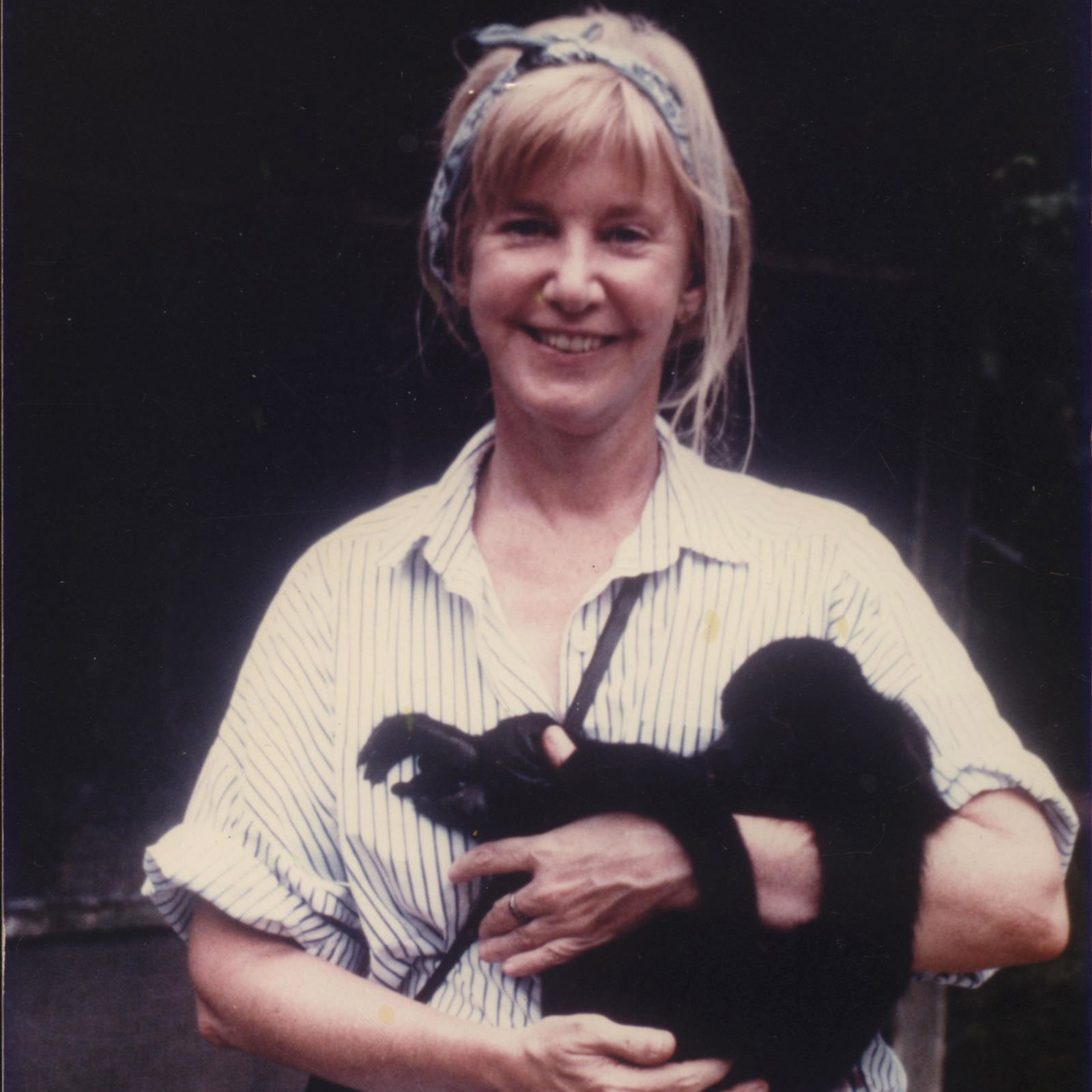 Katharine Milton holding a howler monkey