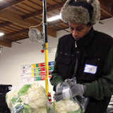 The Alameda County Community Food Bank was an early adopter in formalizing their nutrition policies. Volunteer Dre Dandrewin packages fresh produce. PHOTO: Molly Oleson