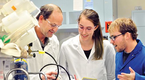 Photo of David Ackerly and students in a lab. 