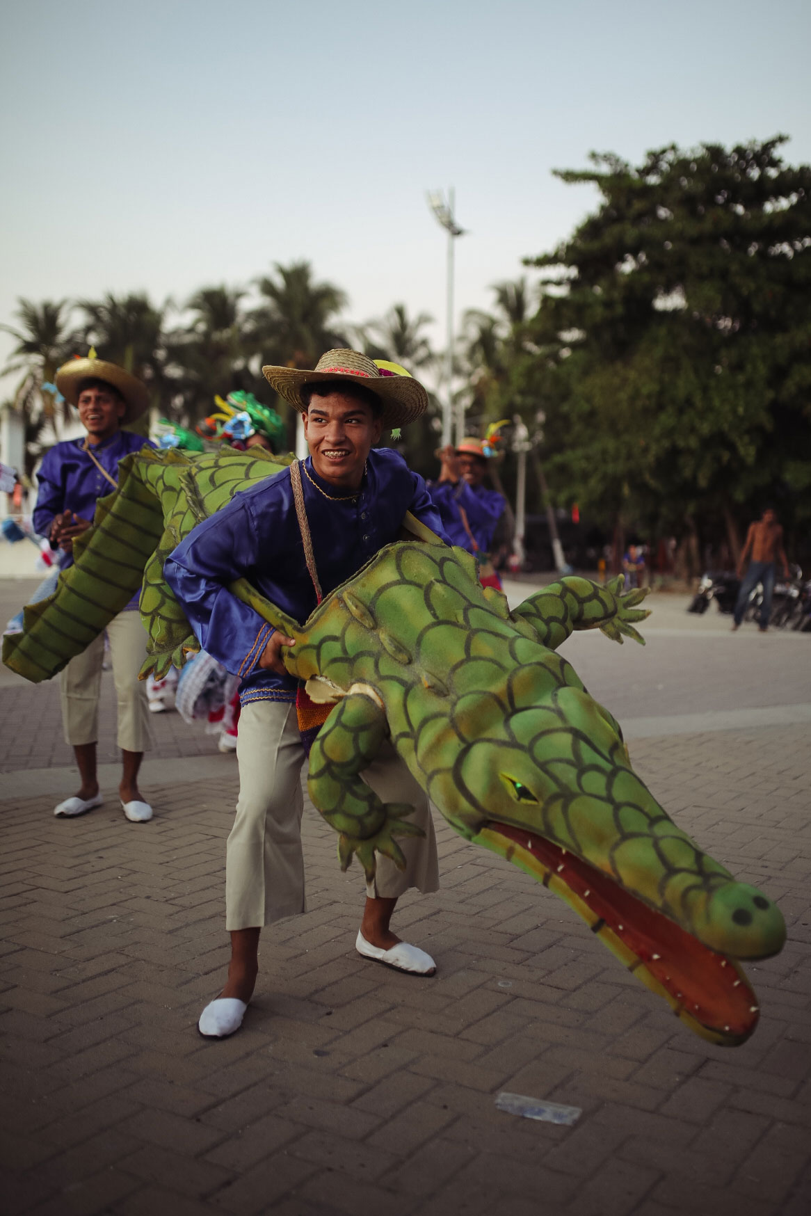 Two Caribbean residents in the Carnival of Barranquilla (2023) dancing and dressed as the American crocodyle (Crocodylus acutus).