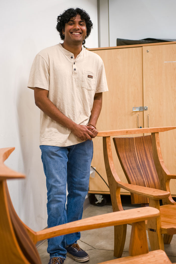 Image of Mayuresh Visswanathan standing around lounge chairs. 