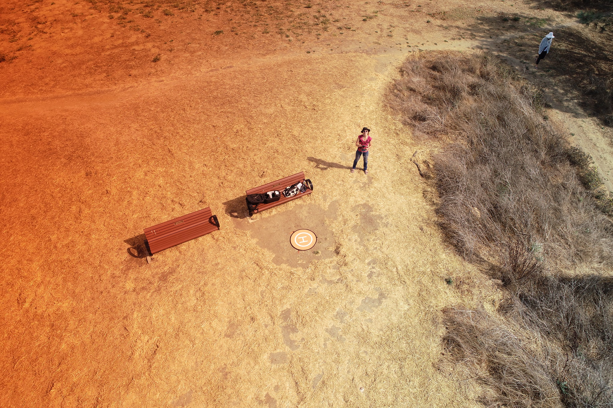 A photo taken by a drone, looking down at the person controlling it