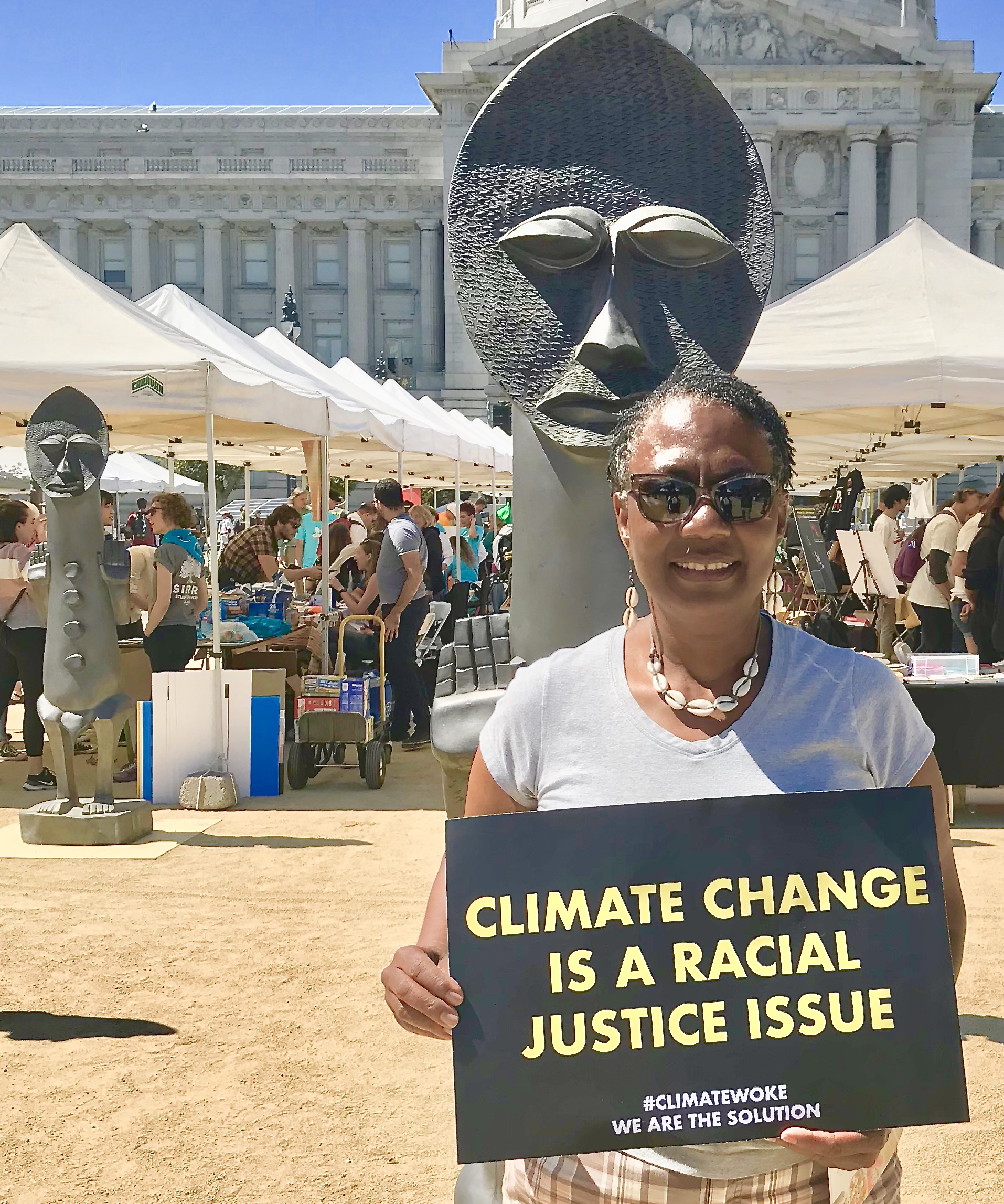 Violet Henderson holding a sign saying "climate change is a racial justice issue."