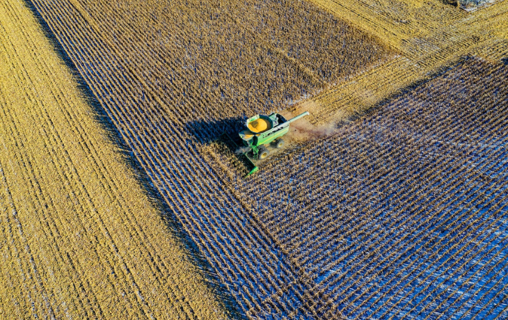 aerial photo of milling truck on field harvesting crops