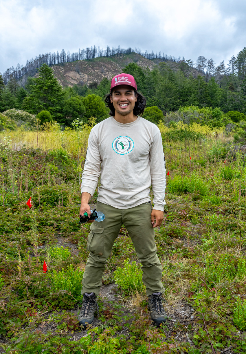 A photo of ESPM graduate student Alexii Sigona standing outdoors.