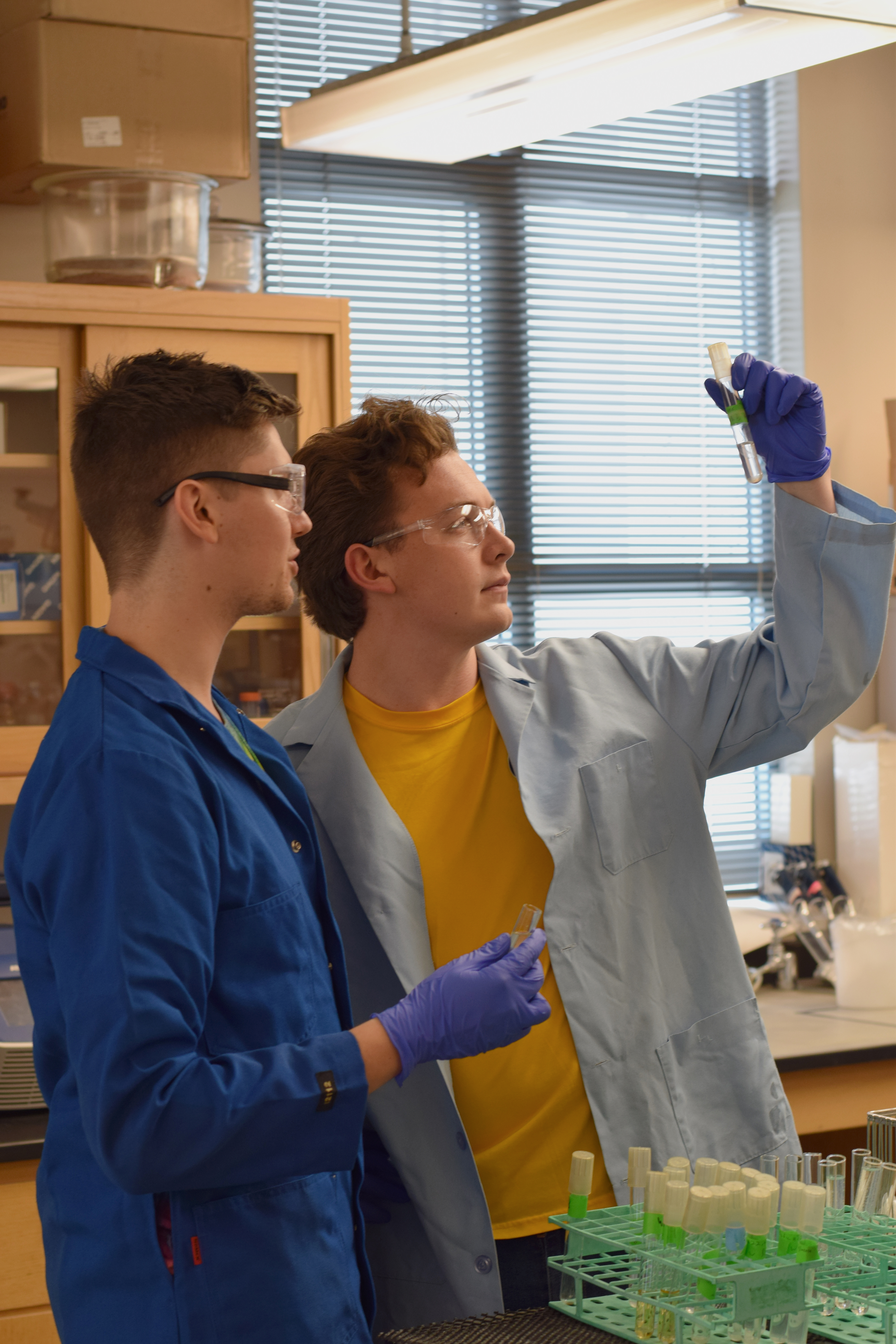 Photo of two students in a lab. 