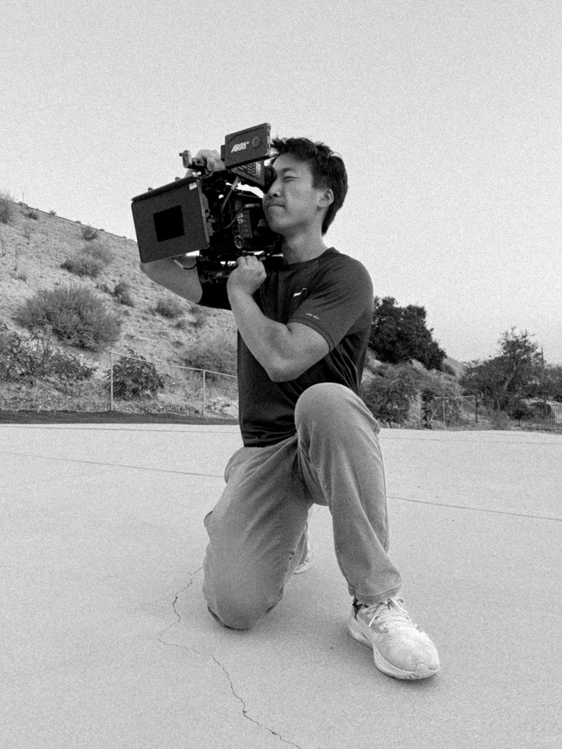 Image in black and white of Zeng in LA holding camera