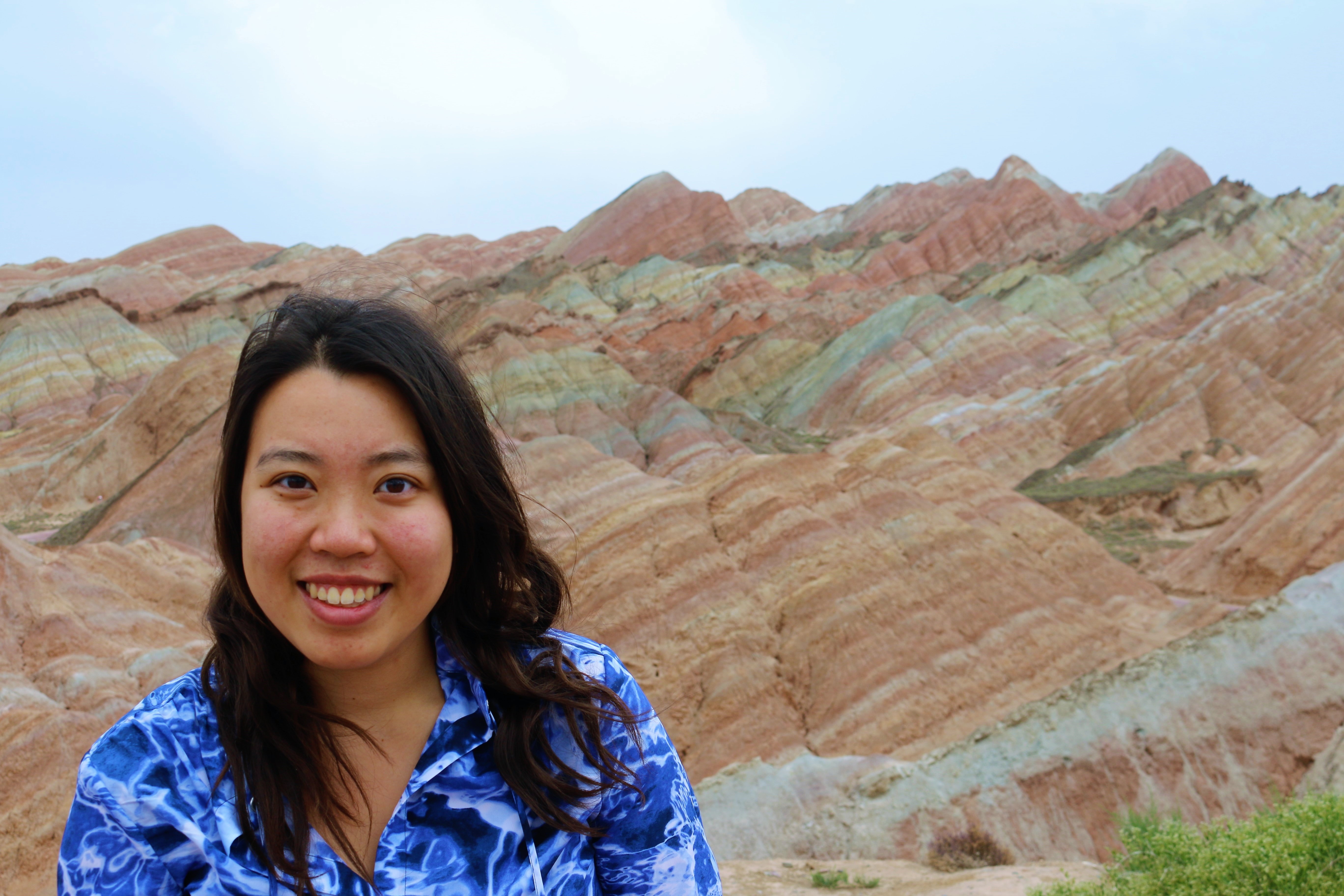 Kimberlie Le in front of a particularly colorful mountain.