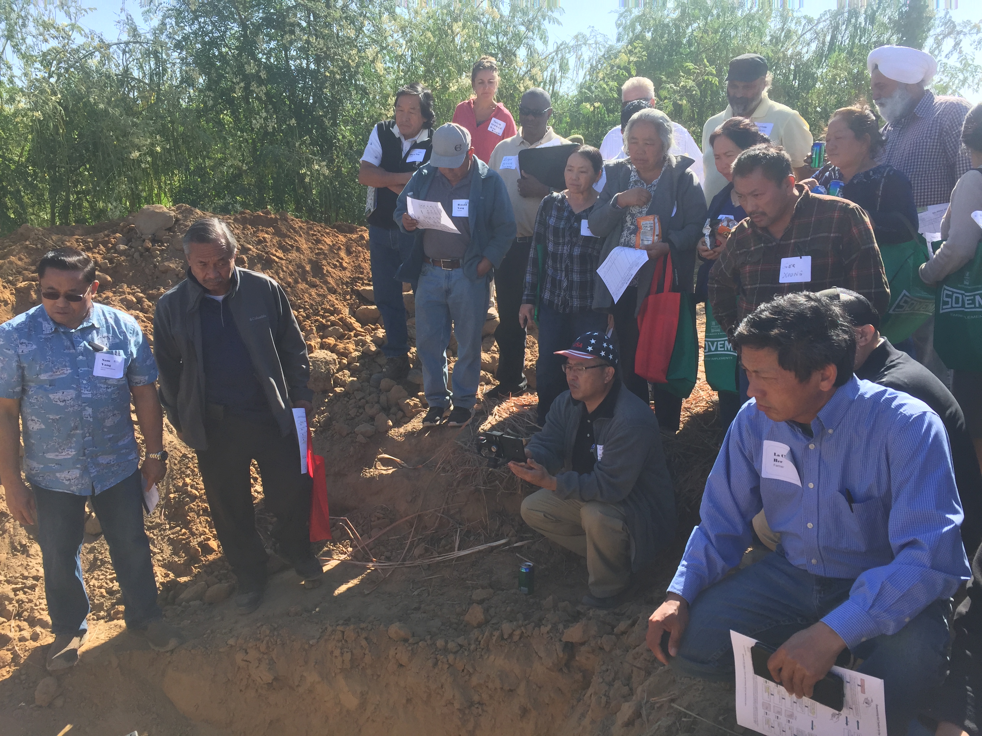 Soil pit demonstration in NRCS led workshop in Fresno County with many participants watching on.