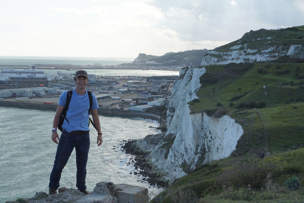 KC Harris stands in front of England's Dover cliffs