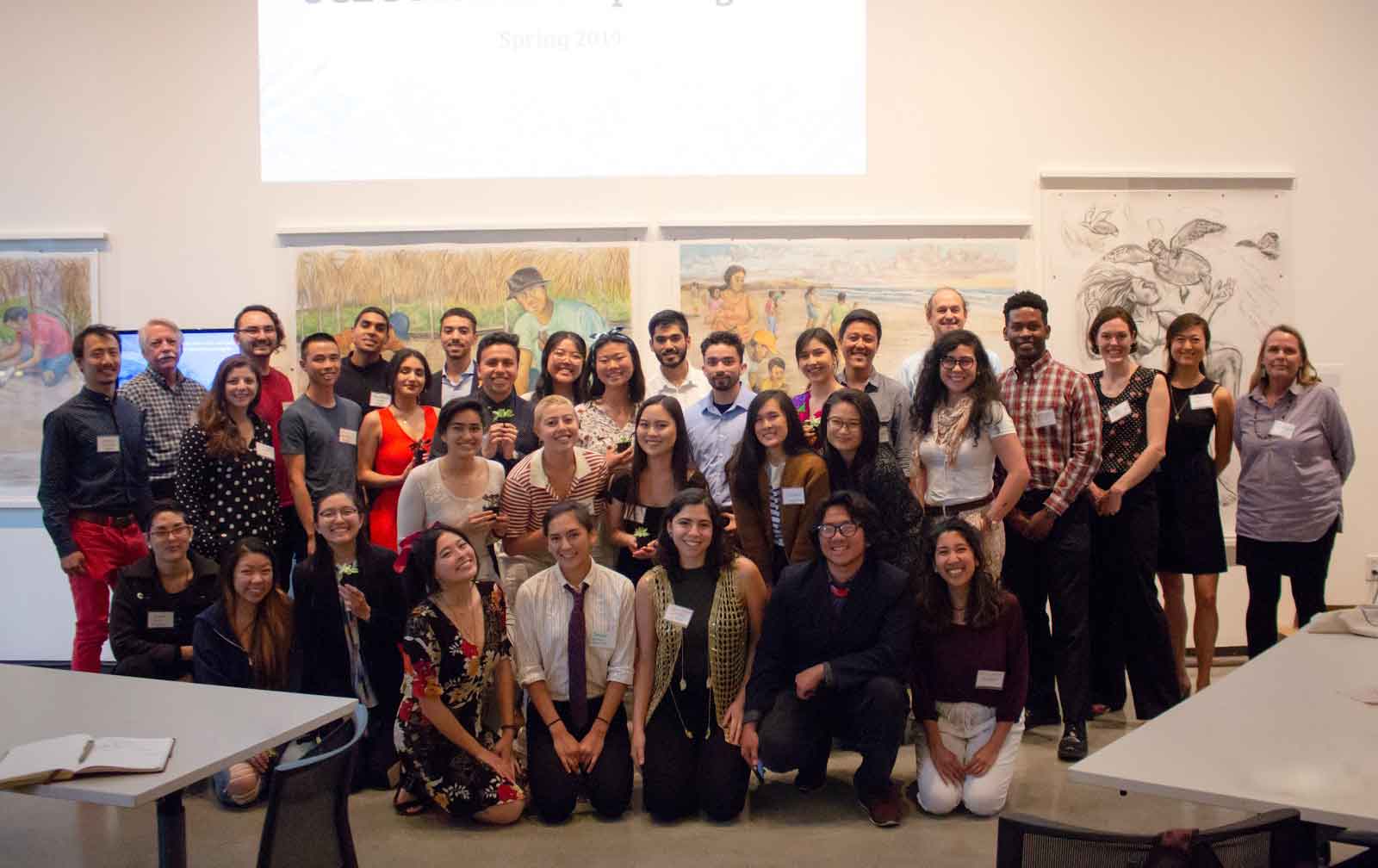A group of students poses for a photo in a conference room. A group of students poses for a photo in a conference room.