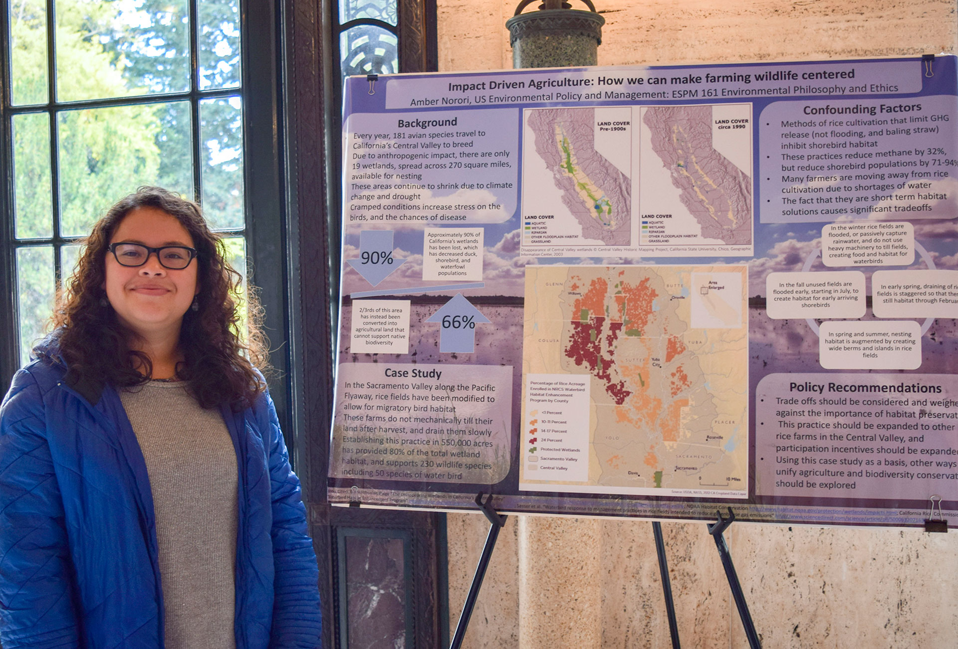 A student presenting her research at a poster session