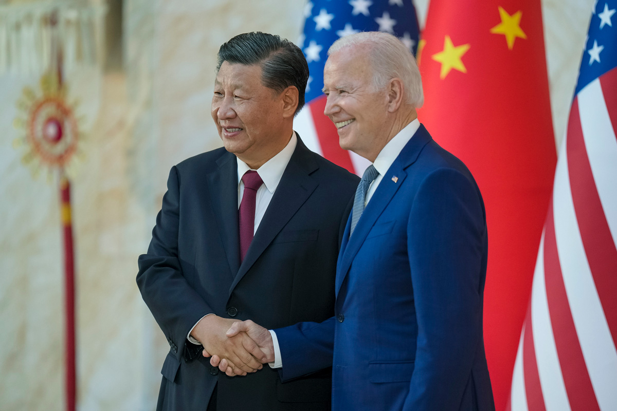 A photo of two men in suits shaking hands.