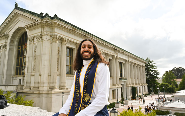 A graduation photo of Wanees Hannan in front of Doe Library