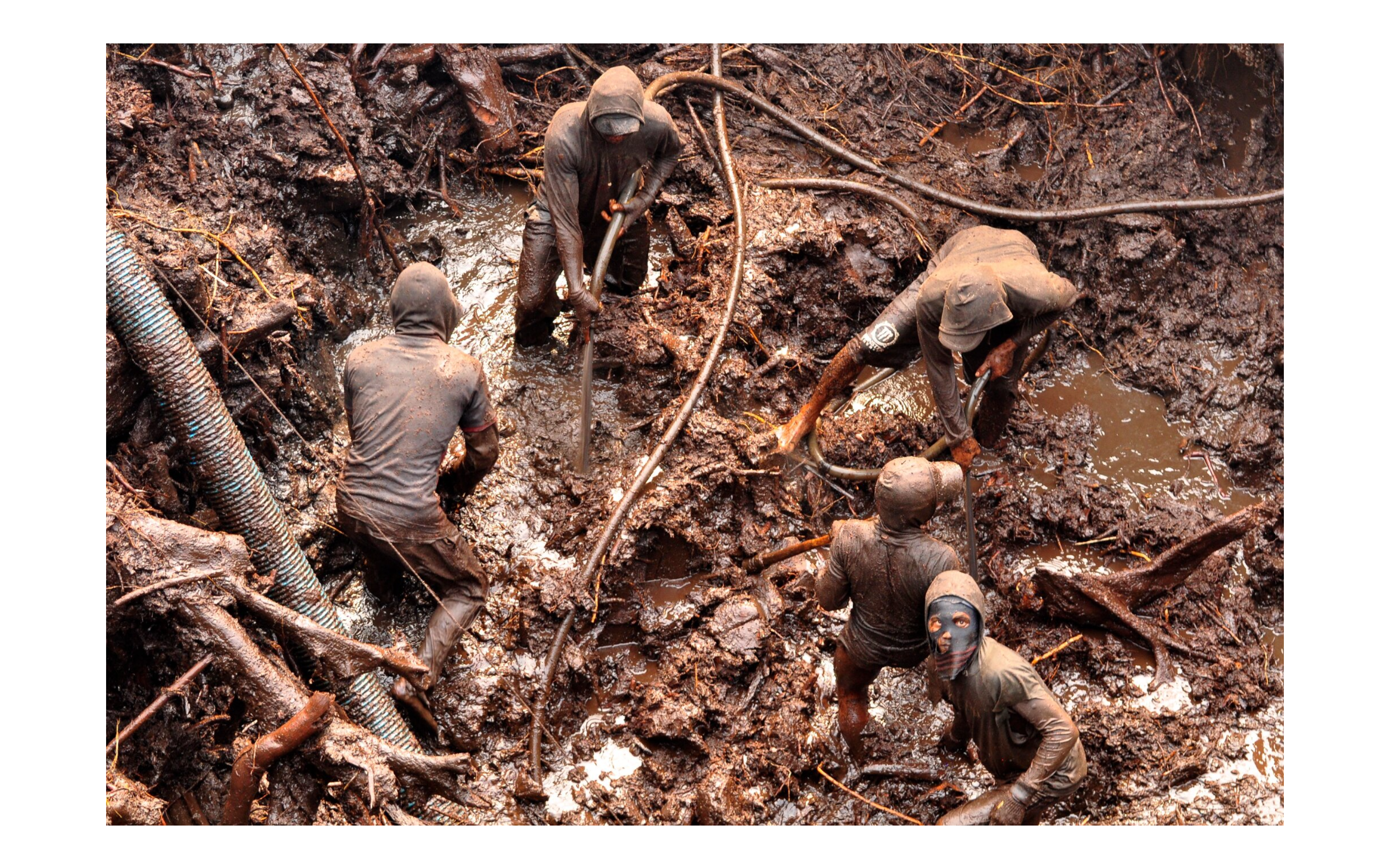 A group of workers laboring in an open pit mine 