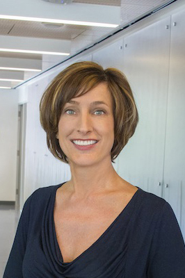 Susan Hubbard smiling in a hallway