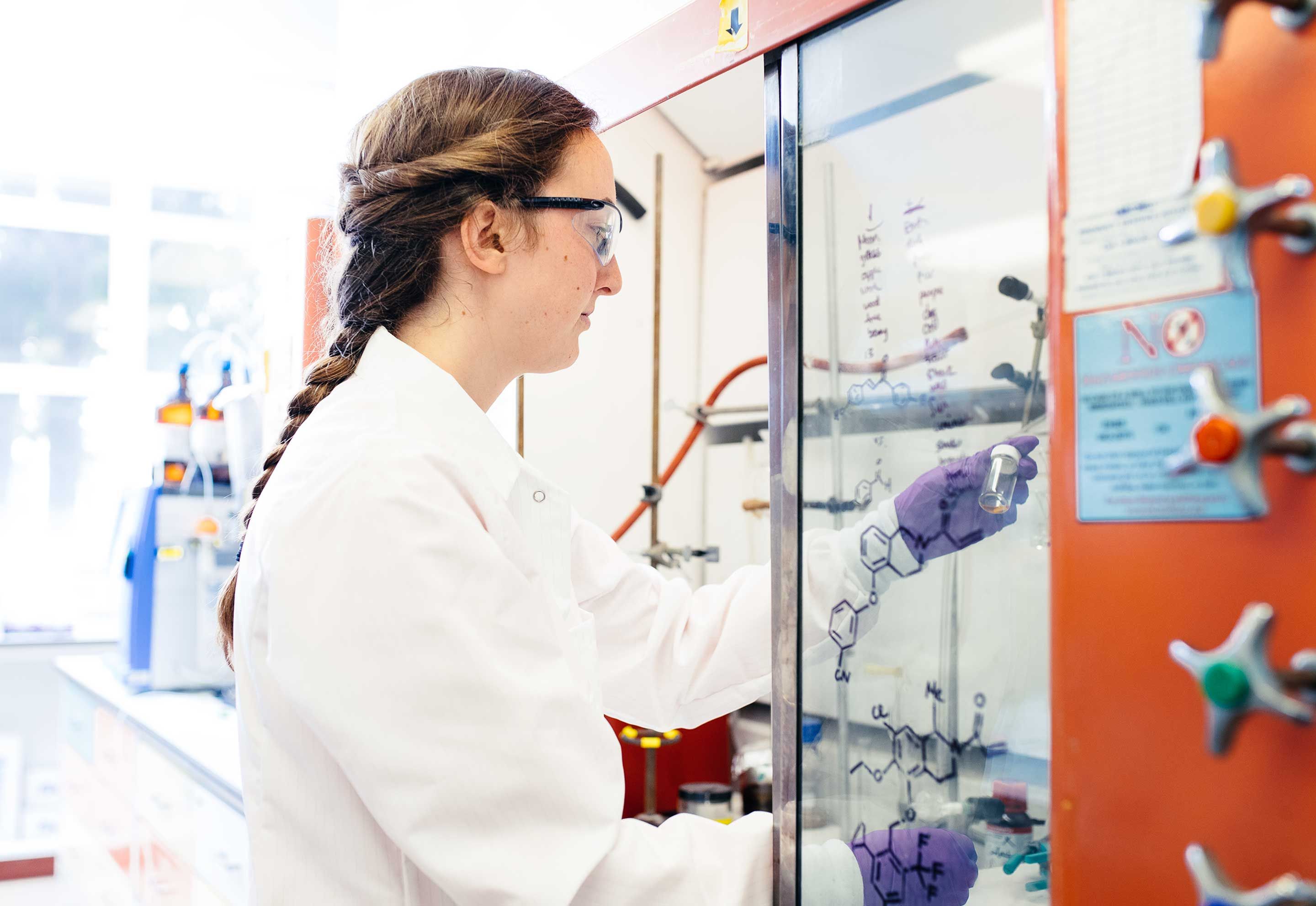 A researcher in a lab holding a test tube