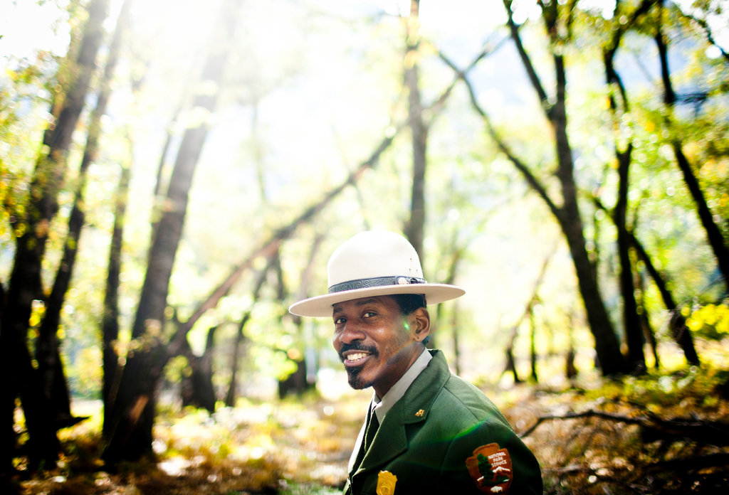 A park ranger smiles for the camera.