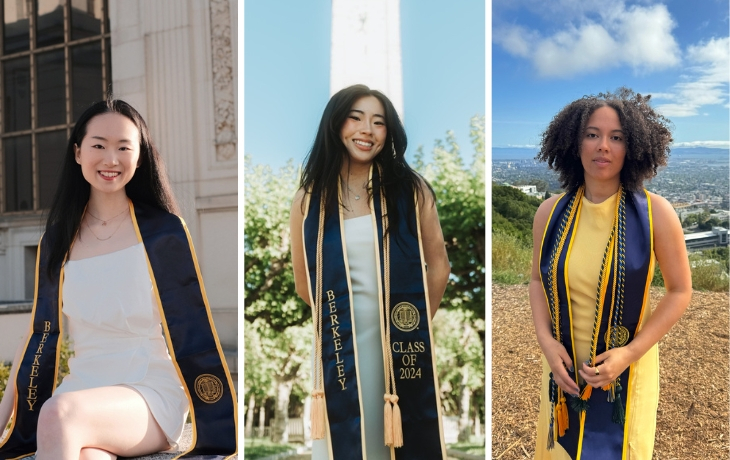 A photo of three women standing outdoors wearing graduation regalia.