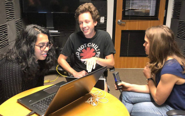 Three students recording an episode of the podcast