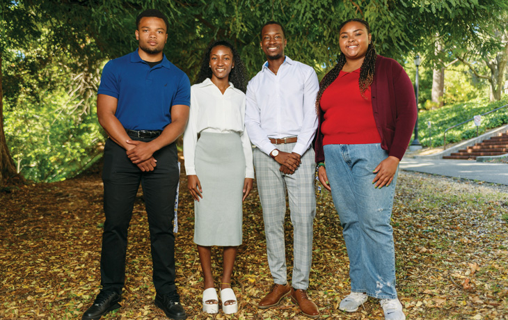 A group photo of four people staring at the camera