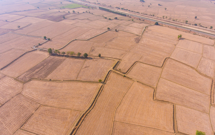 An aerial photo of dry farmland in various plots