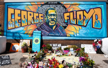 A mural and flowers memorializing George Floyd.