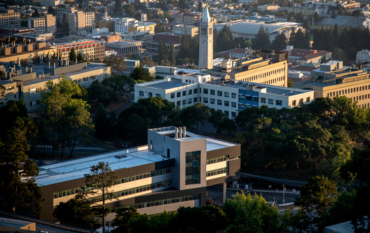 A photo of buildings with the campanile in the background