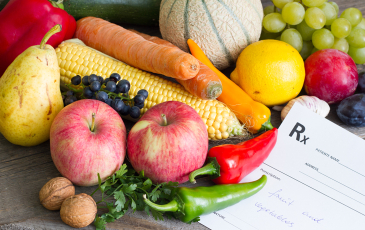A photo of fruits and vegetables near a white prescription slip.