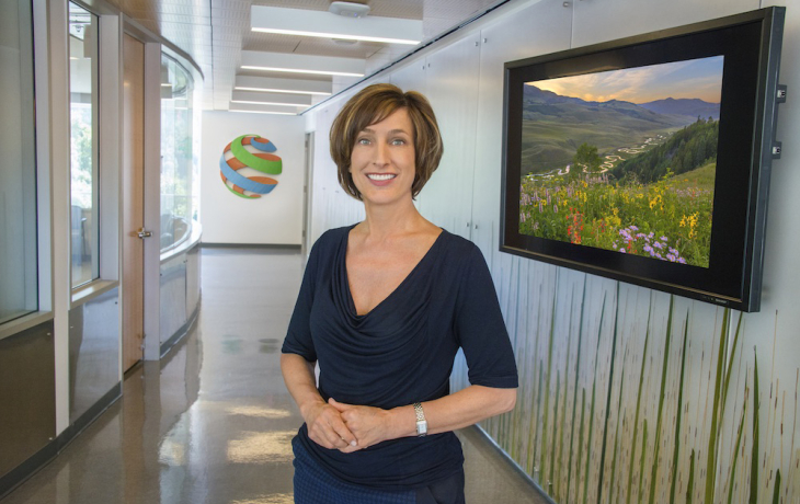 Susan Hubbard smiling in a hallway