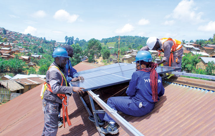 students installing a solar panel