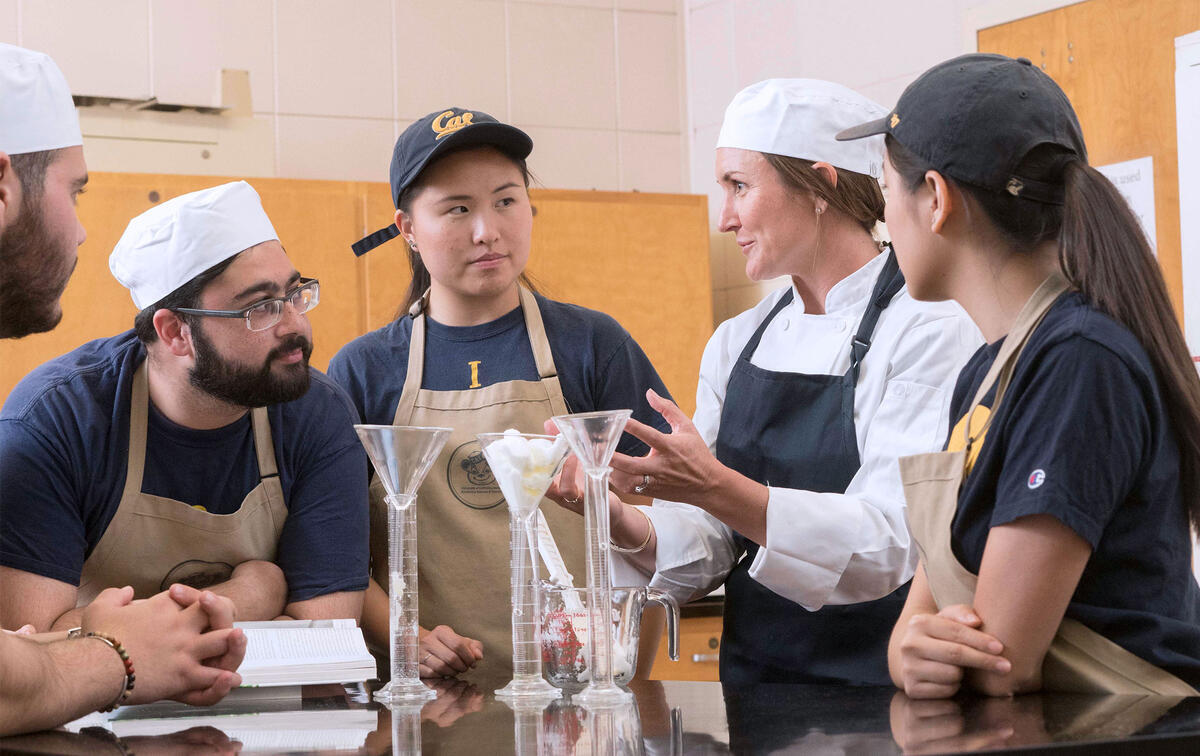 an instructor and students in a teaching kitchen